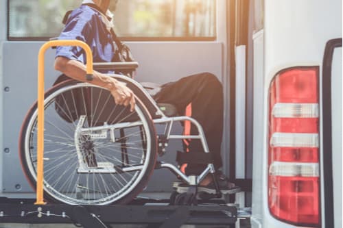 A passenger boarding a bus in a wheelchair