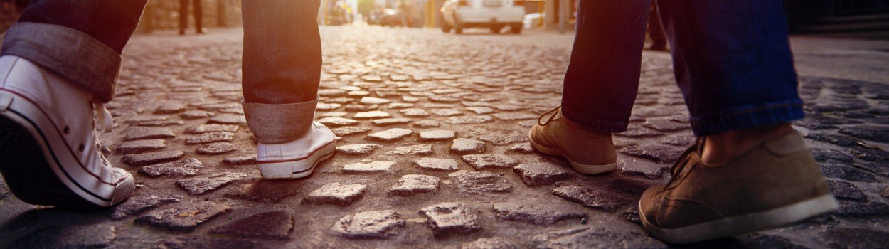 A photo of two peoples' shoes as they walk forward