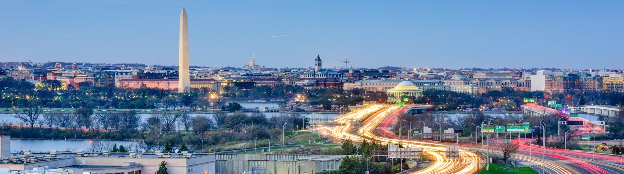A scenic view of Washington D.C highways, with the Lincoln Memorial in the background.