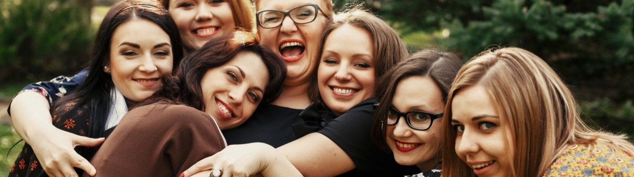 A group of women embracing each other for a photo